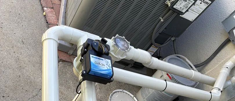 A valve actuator mounted on the diverter valve at a pool equipment pad